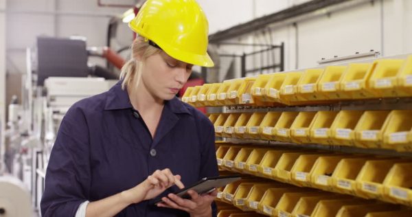 a woman inspector wearing a yellow safety helmet