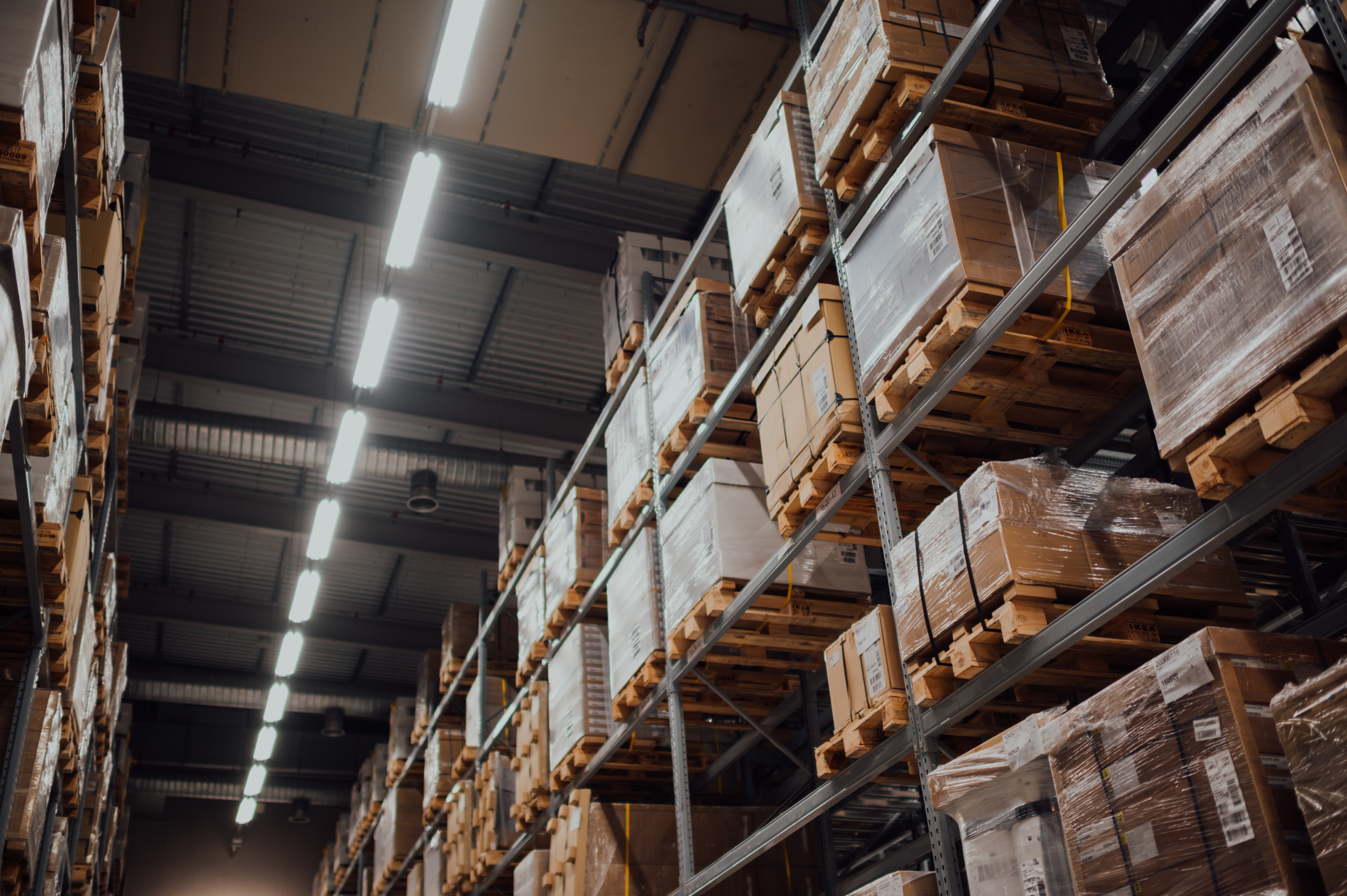 boxes stacked on pallets on shelving