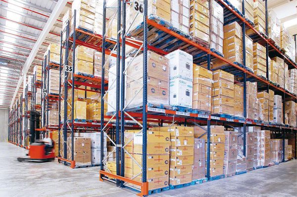 shipping boxes stored on tall pallet racks inside a warehouse