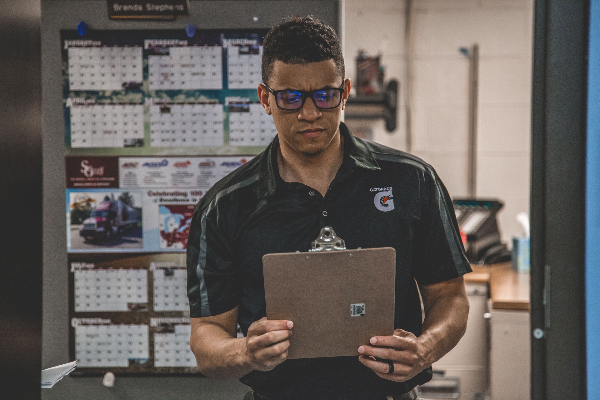 Man reviewing clipboard in uniform