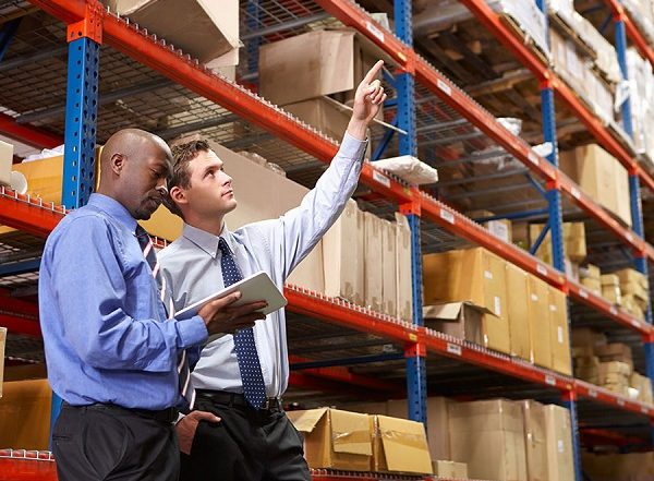 Two business men doing an inventory check in a warehouse