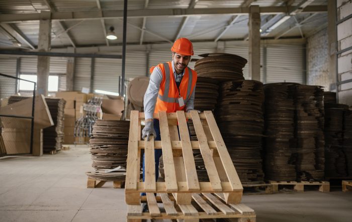 Man working with heavy wooden material